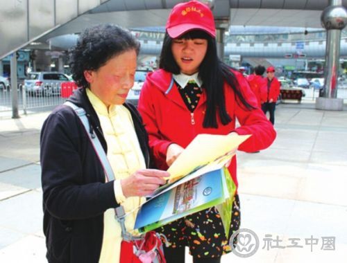 一名社工专业的研究生向市民讲解为老人服务的多种社会工作种类。