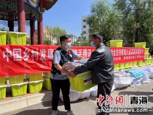 图为志愿者搬运救援物资。